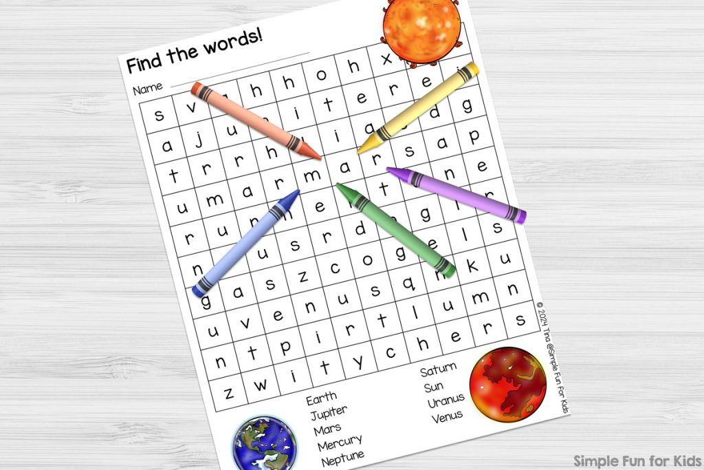 A picture of the free version of the Sun and Planets Word Search printable with a yellow, a purple, a green, a blue, and an orange crayon on top of it around the word "mars".